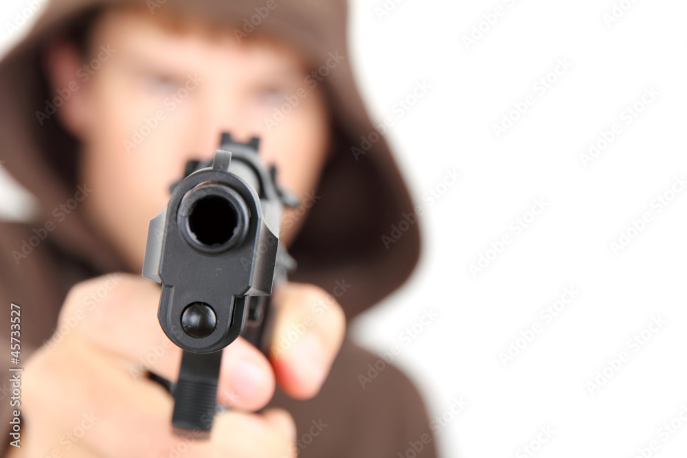 A teenager wearing a hood aiming a gun with white background A teenager wearing a hood aiming a gun with white background