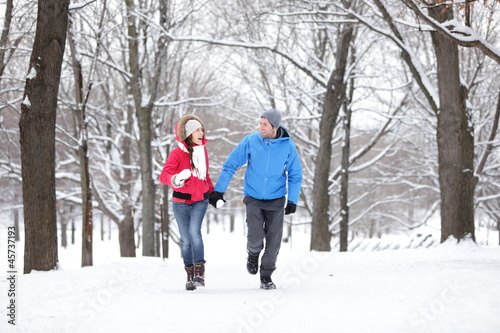 Couple walking in winter forest