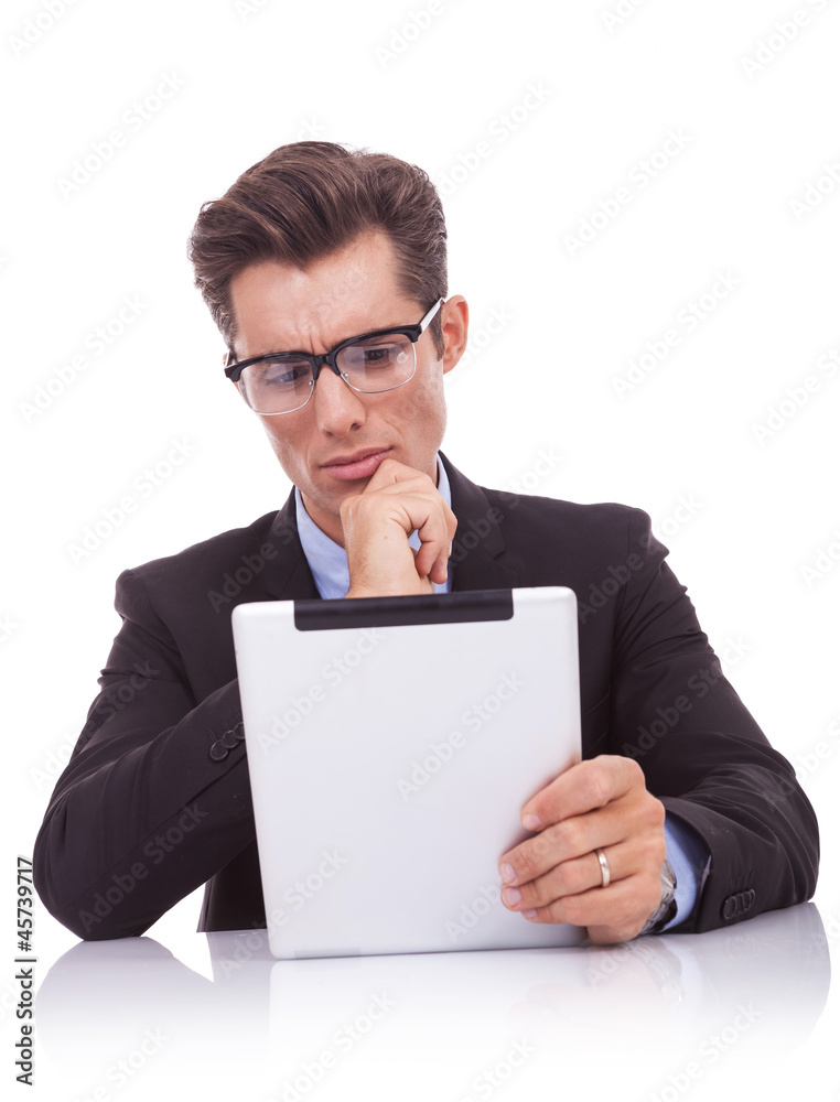 serious business man reading on his tablet pad