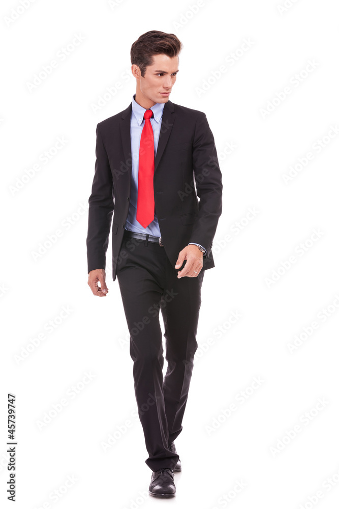 young businessman is walking looking to left side young businessman is walking looking to left side