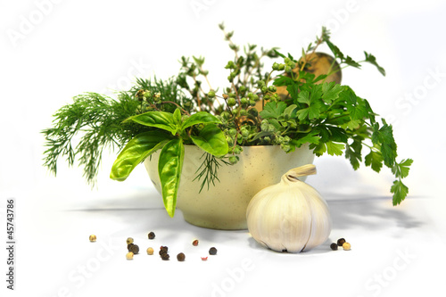 herbs and spices bunch in a bowl with a pestle