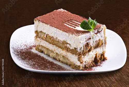 Delicious tiramisu cake on a plate - isolated