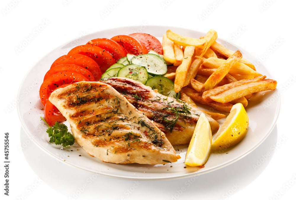 Grilled steaks, French fries and vegetables Grilled steaks, French fries and vegetables