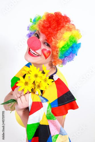 Clown looking to the copy space area in a white studio