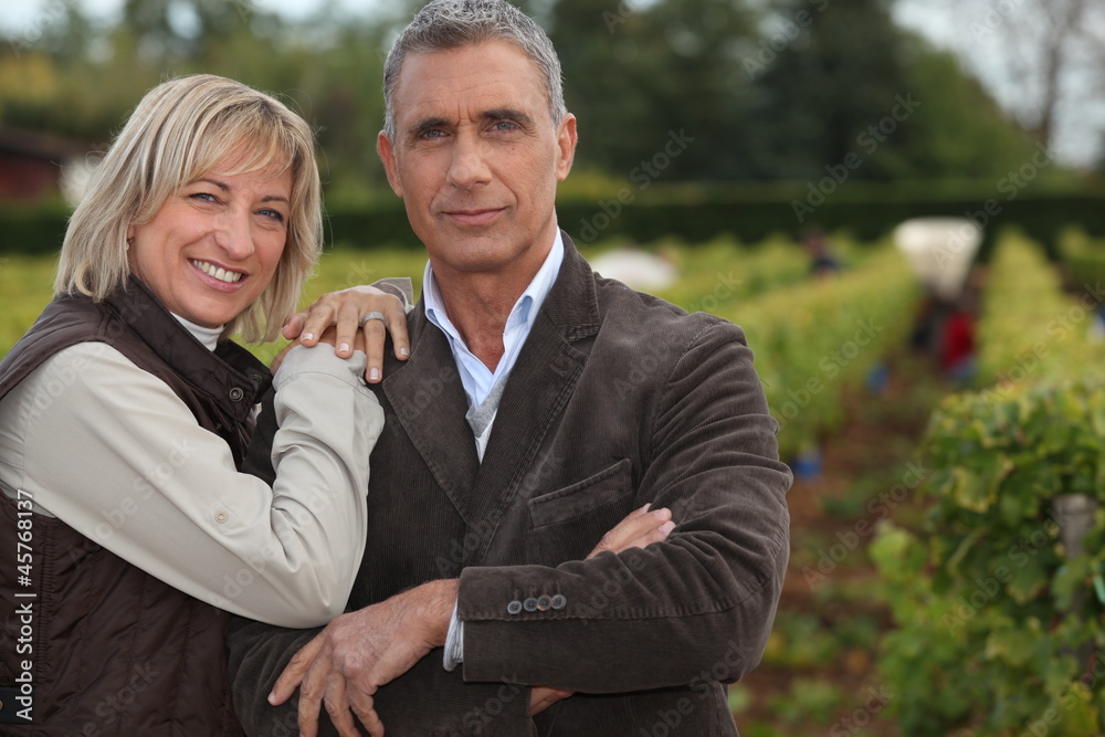 Winegrowers in front of vineyard Winegrowers in front of vineyard