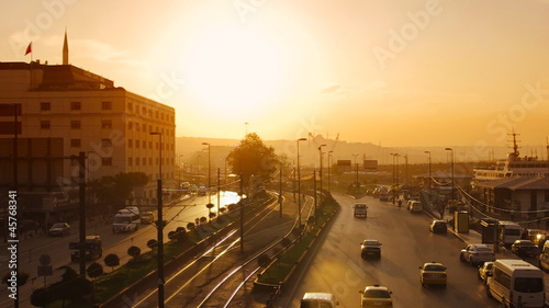 View to the Eminonu port and Ragip Gumuspala street at sunset in photo