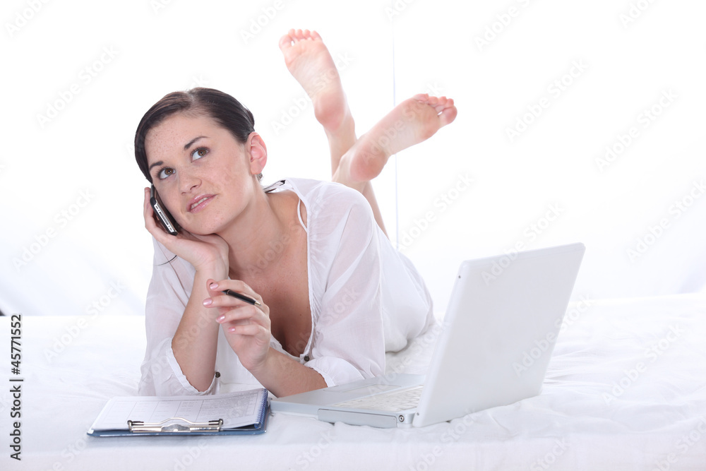 young pretty girl phoning and using her laptop young pretty girl phoning and using her laptop
