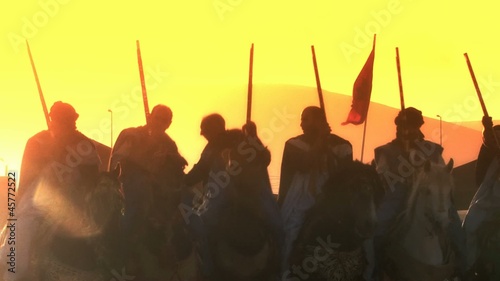 Moroccan knight warriors who have emerged victorious from a battle, celebrating together as friends. Their armor and weaponry showcase their skill and bravery,