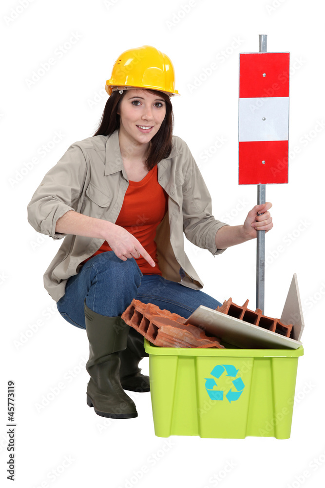 Female construction worker warning you to recycle old material Female construction worker warning you to recycle old material