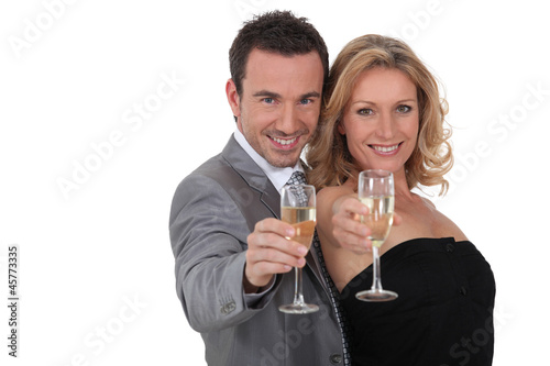 Couple raising champagne glasses