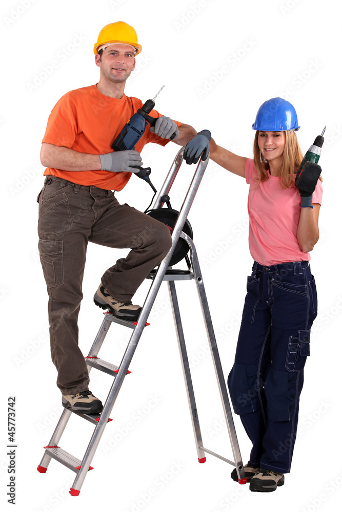 Tradesman posing with his young apprentice Tradesman posing with his young apprentice