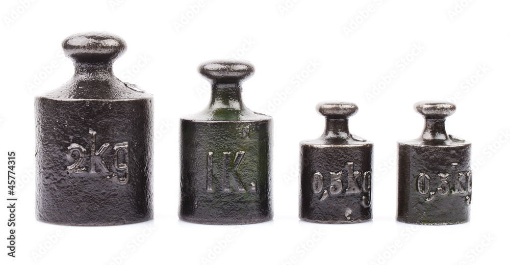 four pieces of old weights isolated on white four pieces of old weights isolated on white