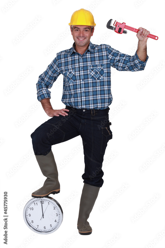 Construction worker with his foot on a clock Construction worker with his foot on a clock