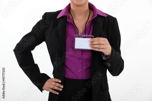 Woman holding a blank name tag