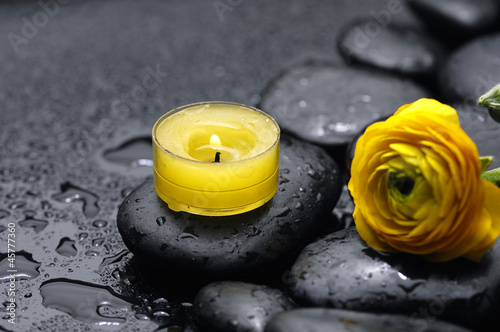 ranunculus with candle and zen stones with zen stones