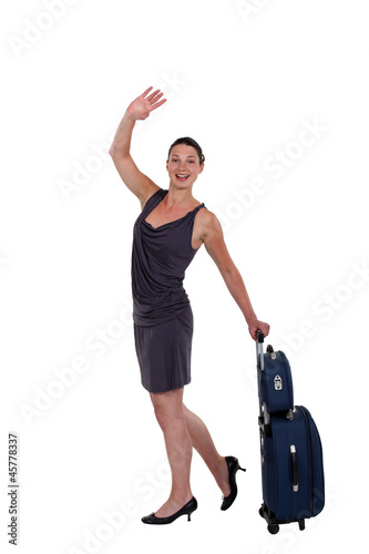 young woman with luggage waving goodbye © auremar