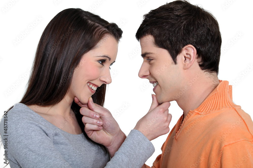Playful man and woman holding their chin Playful man and woman holding their chin