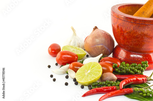 Fresh herbs and spices with wooden mortar