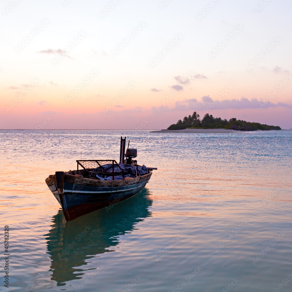 Romantic Tropical Sunset and Vintage Boat, Maldives