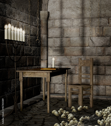 Stół, świecznik i czaszki w starym lochu