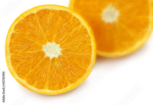 Sliced oranges with selective focus over white background