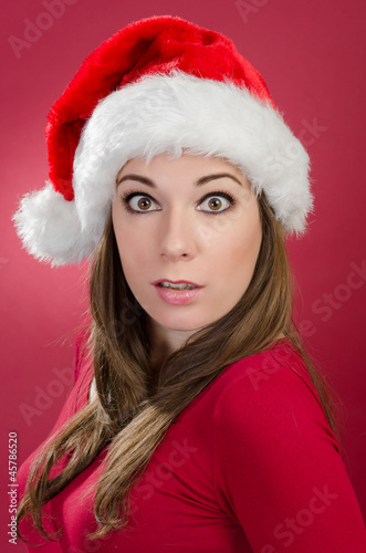 Surprised woman with santa hat