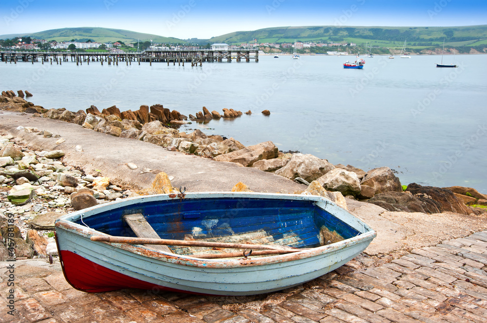 Old rowing boat on launch slipway of seaside town