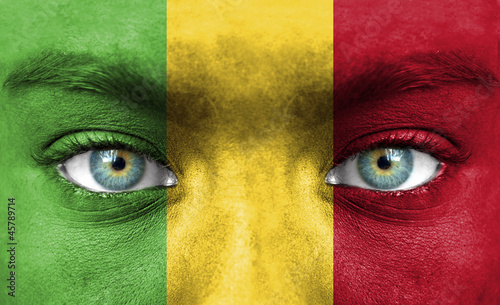 Human face painted with flag of Mali