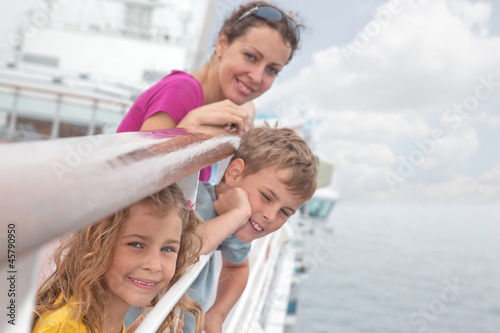 Quadro em tela Mother with children stand on deck of passenger ship