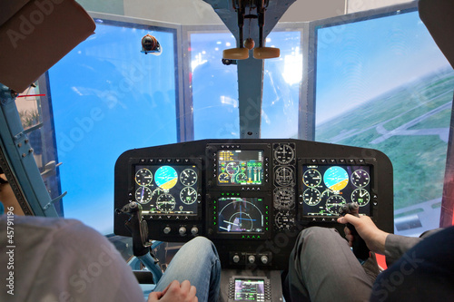 Two guys  flying on helicopter simulator photo