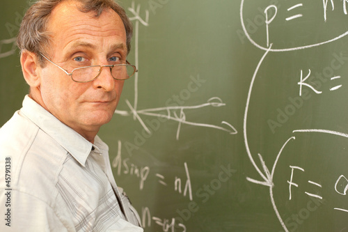 Scientist solves equation on blackboard