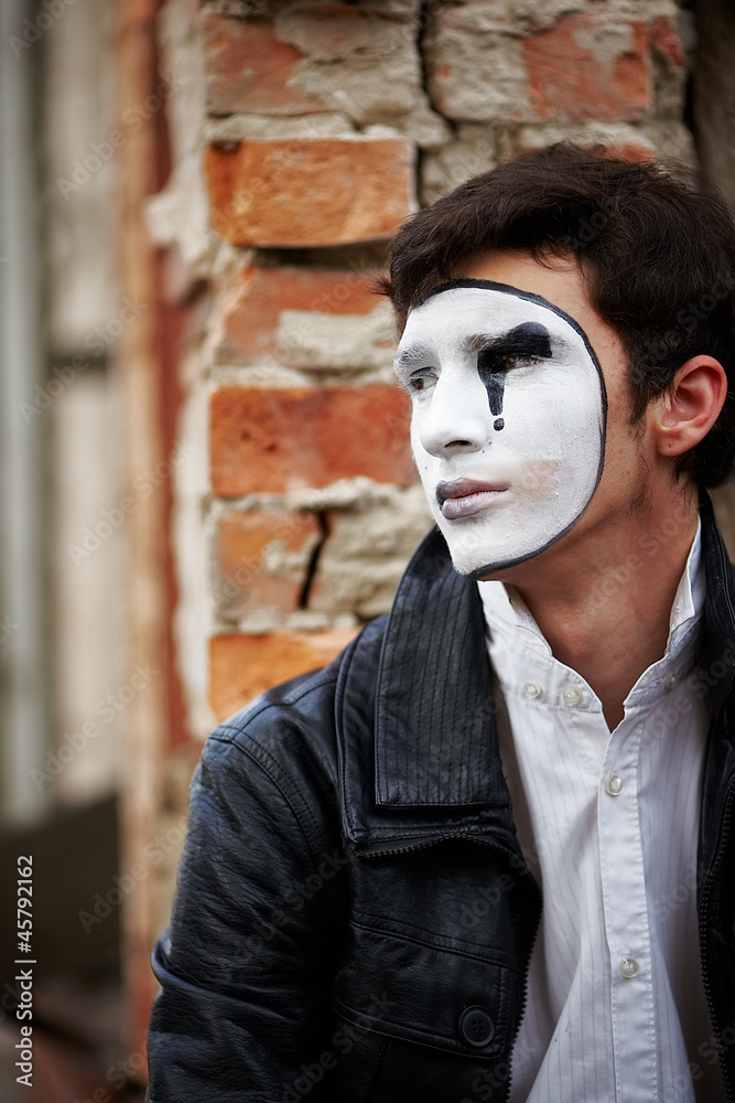 Guy mime against an old brick wall. Guy mime against an old brick wall.