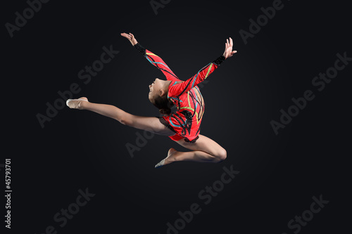 Young woman in gymnast suit posing