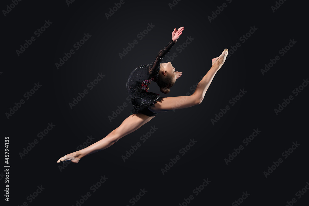 Obraz premium Young woman in gymnast suit posing