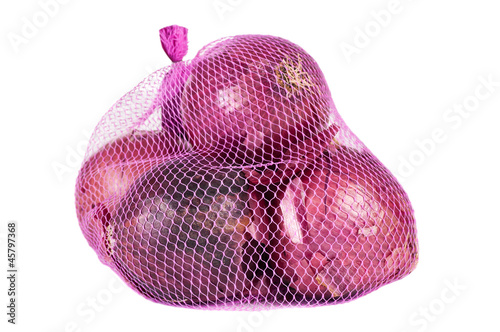 Red onions in a pink bag over a white background