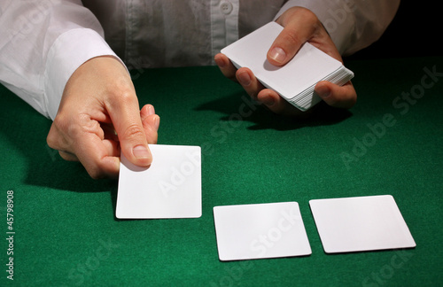 Cards in hands on green table photo