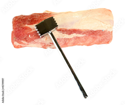raw pork with a meat hammer isolated on white