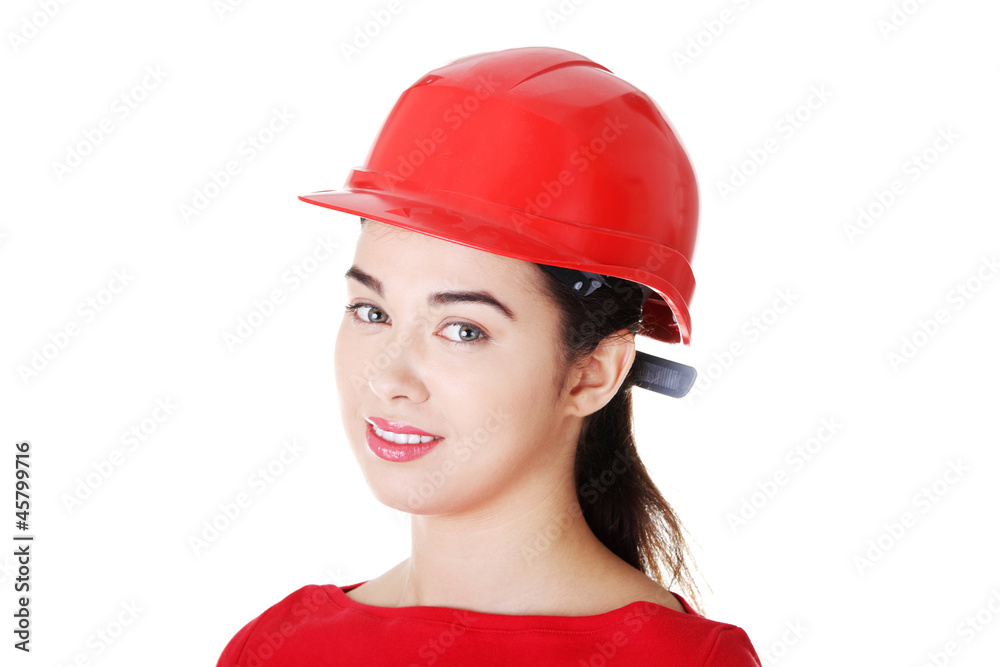 Portrait of confident female worker in helmet.