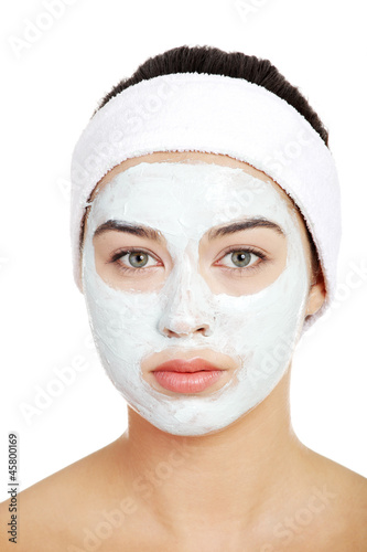 Beautiful woman with clay face mask