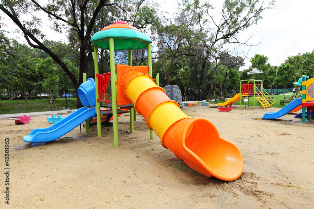 Complex playground set in well-maintained park Complex playground set in well-maintained park