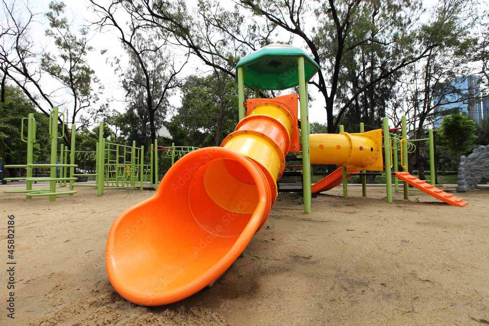 Complex playground set in well-maintained park Complex playground set in well-maintained park