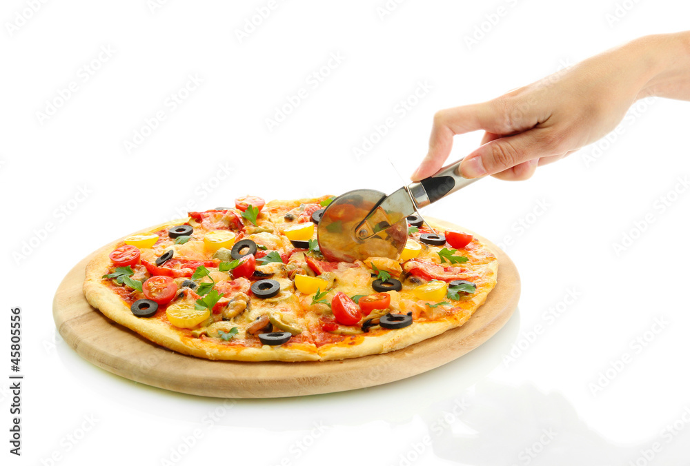 woman's hand with a knife cut the pizza