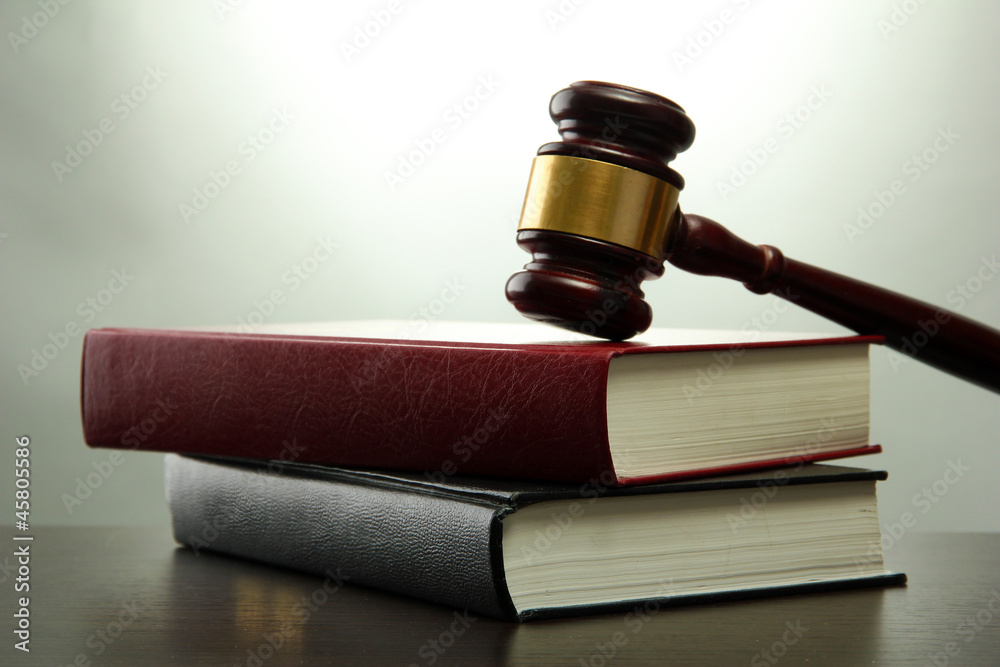wooden gavel and books on wooden table,on grey background wooden gavel and books on wooden table,on grey background