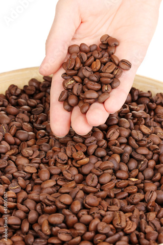 Coffee beans in hand close-up