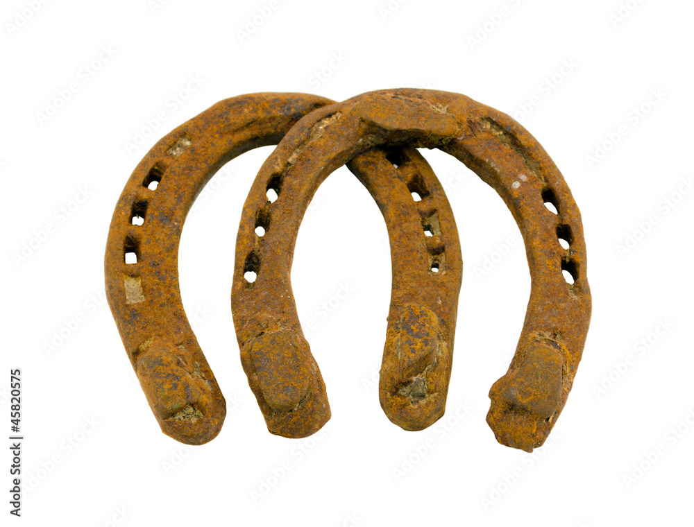 Retro rusty pair of horseshoes isolated on white
