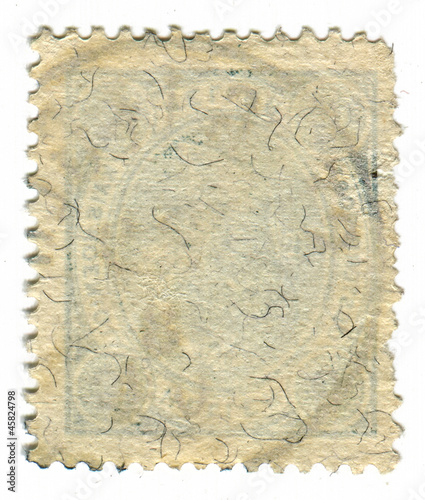 The reverse side of a postage stamp.