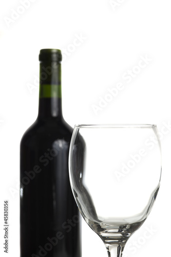 Glass and wine-bottle isolated on white
