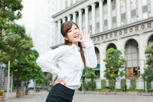 Beautiful business woman walking outside her office