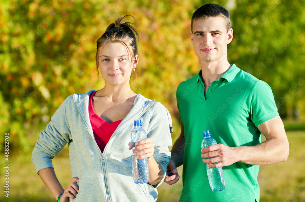 Man and woman drinking from bottle Man and woman drinking from bottle