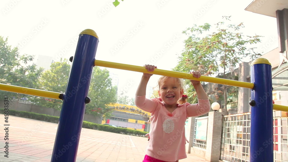 Happy little girl climbing in playground Happy little girl climbing in playground